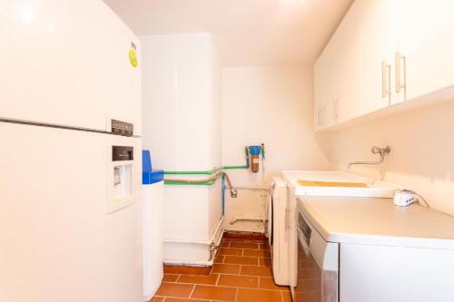 a small kitchen with white cabinets and a sink at Casale Bianca Luce in Santa Luce