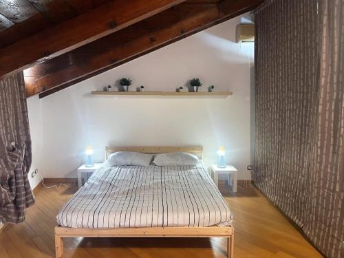 a bedroom with a bed and two lights on two tables at Viale Monza Chic Stay - Affitti Brevi Italia in Milan