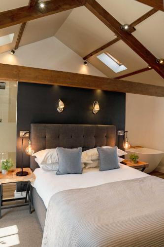a bedroom with a large bed with two pillows at Yorebridge House in Bainbridge