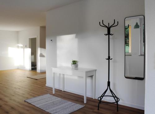 a room with a white table and a mirror at Glöckle Mühle, Ferienwohnungen und Camping mit Sauna in Herbolzheim