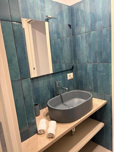 a bathroom with a sink and a mirror at Casa Varone del Vesuvio in Torre Annunziata