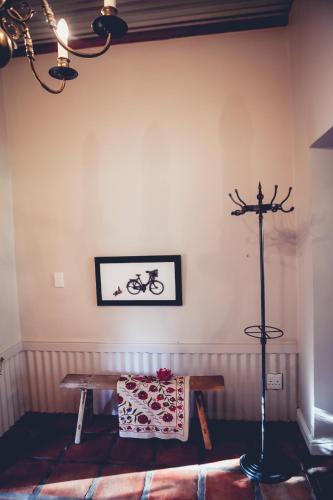 a room with a table and a bike on the wall at Station House Simondium in Simondium