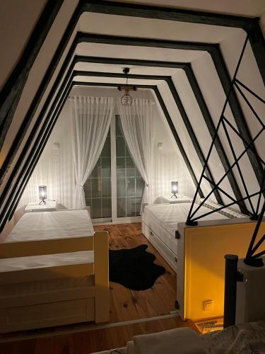 a bedroom with two beds and a large window at Kalina Lux House in Bijelo Polje