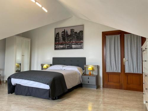 a bedroom with a large bed and a window at Finca la Tierruca de Cudon in Cudón