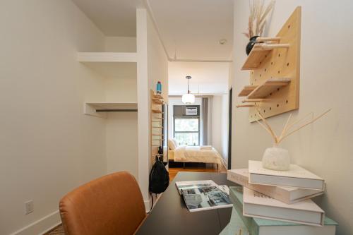 a room with a desk and a table with a chair at Lamartine Chelsea in New York