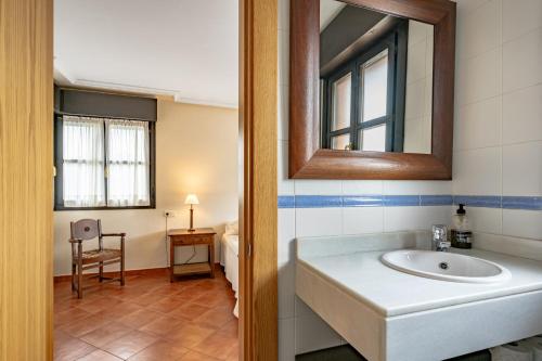 a bathroom with a sink and a mirror at Chalet Picu Fontanielles en Colunga in Colunga