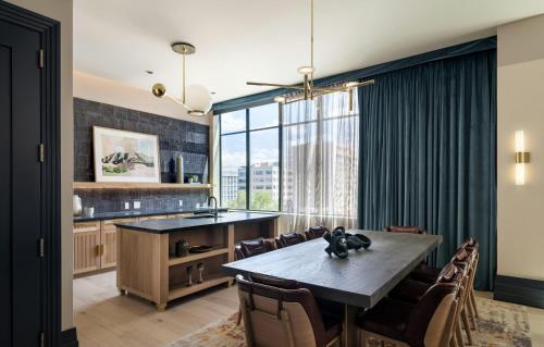 a dining room with a table and chairs at Clayton Hotel & Members Club - Cherry Creek, Denver in Denver
