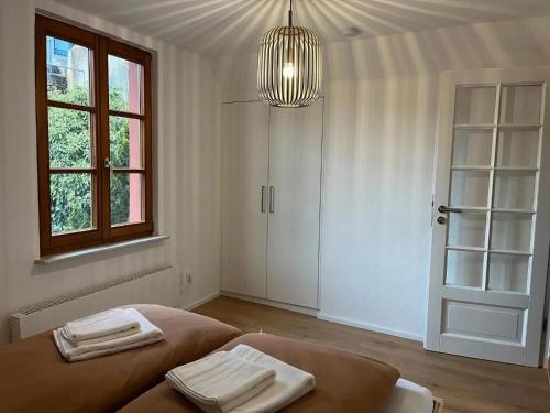 a white room with a bed with towels on it at Ferienhaus Schmuckstück in Schiltach
