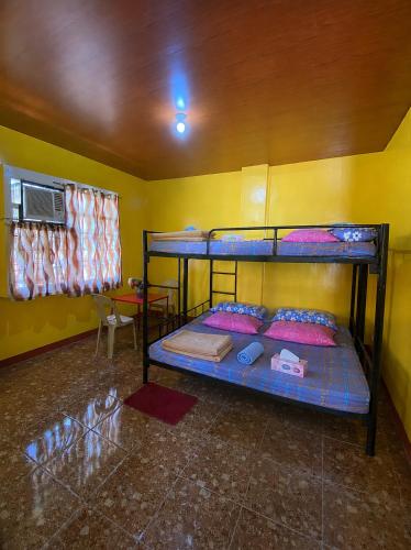 a bedroom with two bunk beds in a room at Polangui Transient Room A Simple Transient House in Polangui