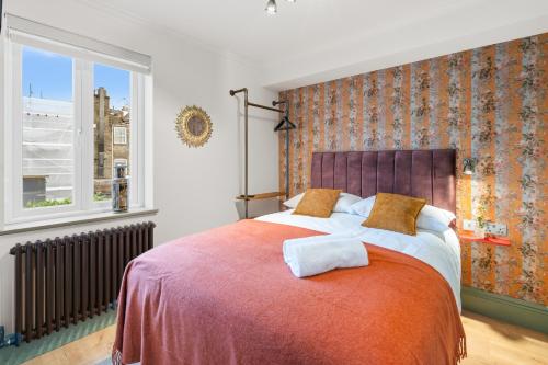a bedroom with a large bed and a window at Upper Victoria in London