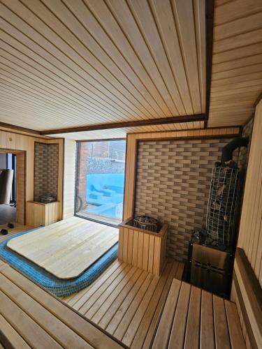 a room with a large window in a sauna at Panorama Lux Guest House in Chimgan