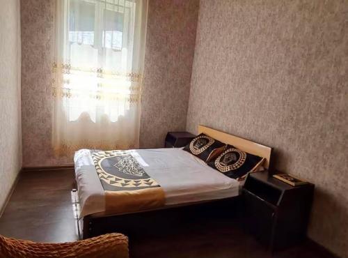 a bedroom with a bed with pillows and a window at Debi in Lentekhi