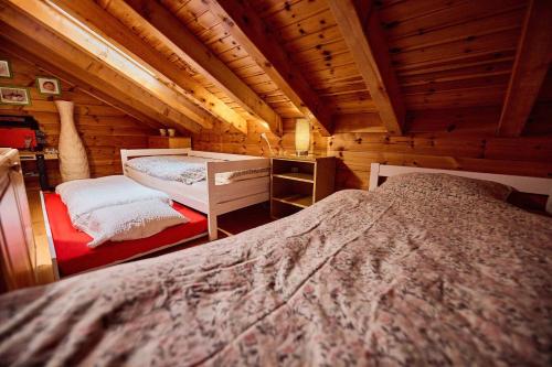 a bedroom with two beds in a wooden cabin at Chalet Louchelet in Hérémence