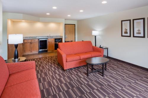 a living room with a couch and a table at AmericInn by Wyndham Sartell in Sartell