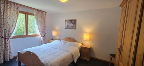 a bedroom with a bed and a window at River Dream in Val-d'Illiez