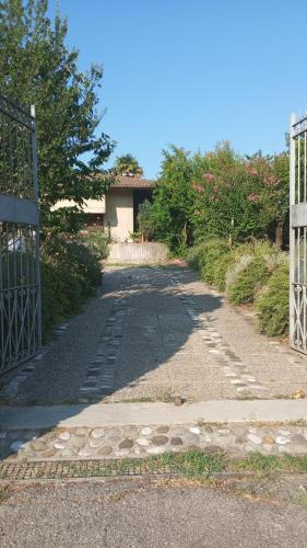 an empty driveway with a gate and a house at Casa Rosmarina in Pieve di Soligo