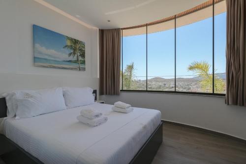 a bedroom with a large bed with towels on it at Hotel Olserd in Ksamil