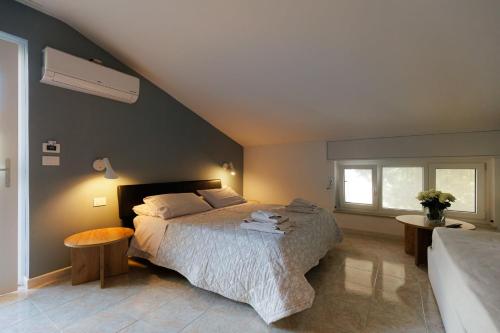 a bedroom with a large bed and a window at Bed & Breakfast L'Albero Maestro in Borgofranco dʼIvrea