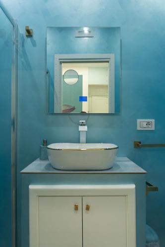 a bathroom with a white sink and a mirror at Na Suite QuartieriSpagnoli in Naples