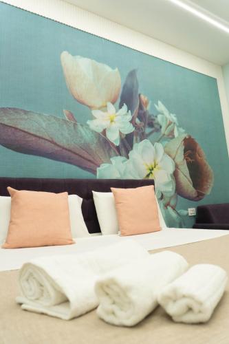 a bedroom with a bed with a painting on the wall at Na Suite QuartieriSpagnoli in Naples