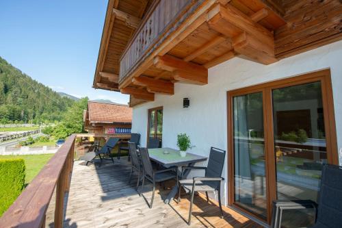 a patio with a table and chairs on a deck at Appartement Neumayer in Viehhofen