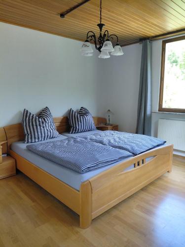 a bedroom with a bed with a blue comforter at Rurterasse in Monschau