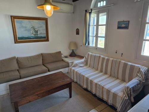 a living room with a couch and a coffee table at Above the Blue in Agios Sostis