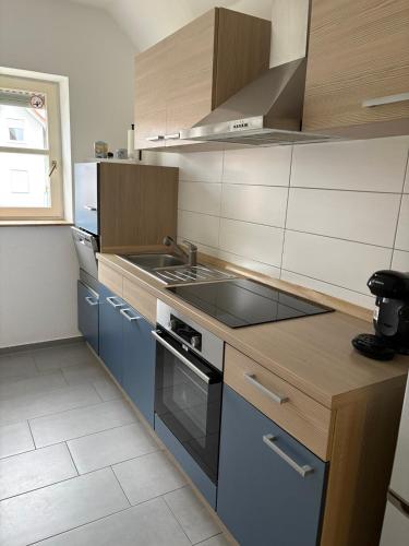 a kitchen with a sink and a stove at Großzügiges Design-Loft in Aulendorf in Aulendorf
