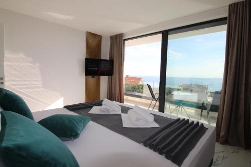 a bedroom with a bed with a view of the ocean at Villa New York in Novalja