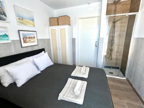 a bedroom with a shower and a bed with towels at Paisaje Lunar in Tinajo