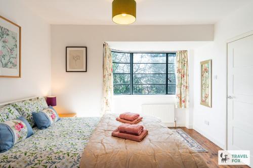 a bedroom with a large bed and a window at Springfield House in Cheadle