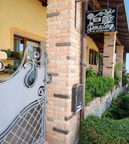 a door to a building with a sign on it at Casa Silius in Silìus