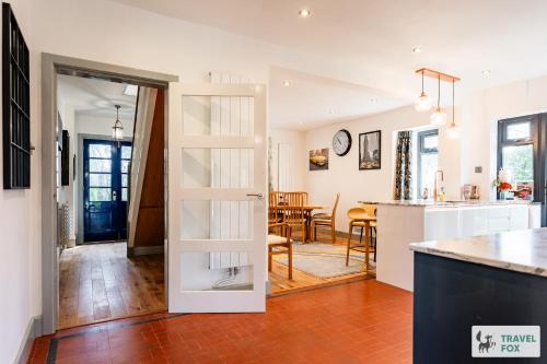 a kitchen and living room with a door leading to a dining room at Springfield House in Cheadle