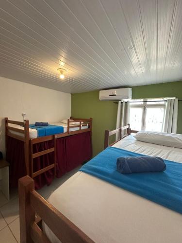 a bedroom with two beds and a window in it at Tepuy Hostel in Boa Vista