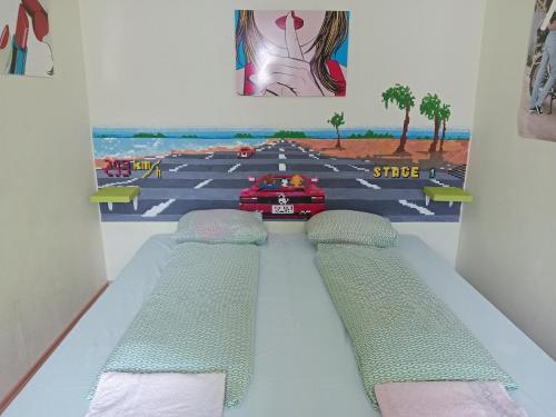 a room with two beds and a painting of a street at Ruta 80 Hostel in Brno