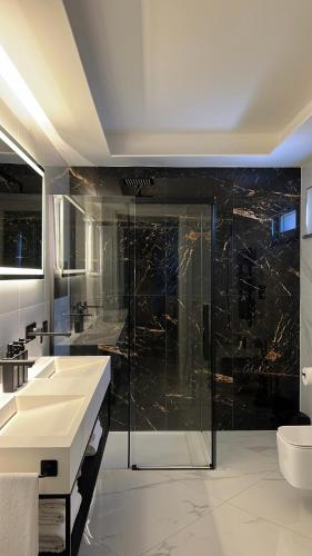 a bathroom with a glass shower and a sink at Green House in Vico Equense
