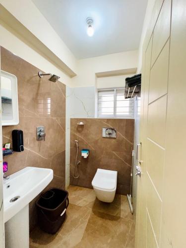 a bathroom with a toilet and a sink at Namma Suites cozy 1BHK Stay Near Koramangala BTM layout in Bangalore