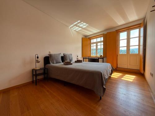a bedroom with a large bed in a room at Castelo 48 in Lamego