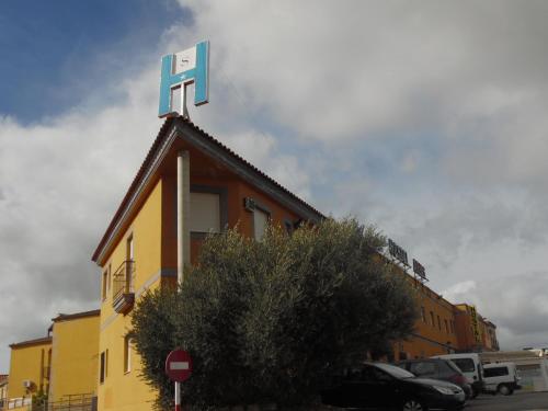 a building with a sign on the top of it at Hostal Arias in Zafra