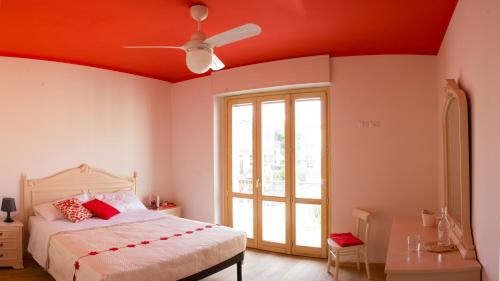 a bedroom with a bed and a ceiling fan at Arcobaleno B&B in San Benedetto del Tronto