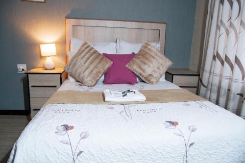 a bedroom with a bed with a towel on it at Dam View Guest house in Bokong