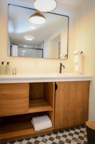 a bathroom with a sink and a large mirror at Arkouda House in Big Bear Lake