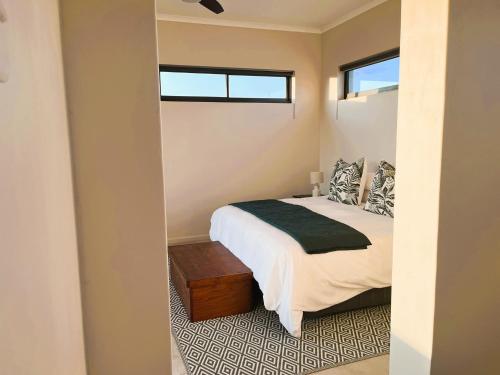 a bedroom with a bed and a window at Olive Grove Addo in Addo