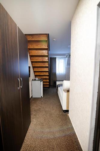 a room with a bedroom with a bed and a door at Hanu Satului in Constanţa