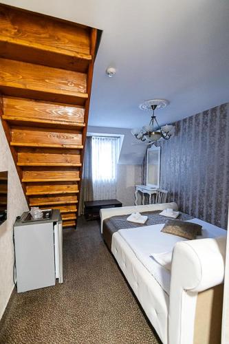 a bedroom with a large bed and a staircase at Hanu Satului in Constanţa