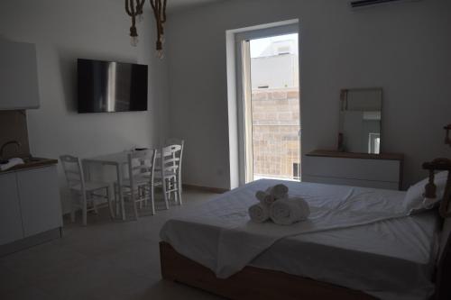 a bedroom with a bed with two towels on it at Terrazza sul Borgo in Polignano a Mare