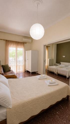 a large bedroom with two beds and a large mirror at Ioannis Schinas Studios in Loutra Edipsou