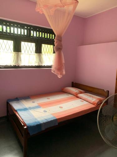 a bed in a room with a window at Emerald canopy retreat in Kandy