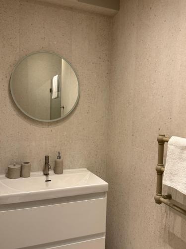 a bathroom with a white sink and a mirror at OrkanaApart in Nowy Targ