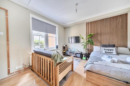 a bedroom with a bed and a window at Chic Flat Hideaway with Private Courtyard - Pass the Keys in Guildford